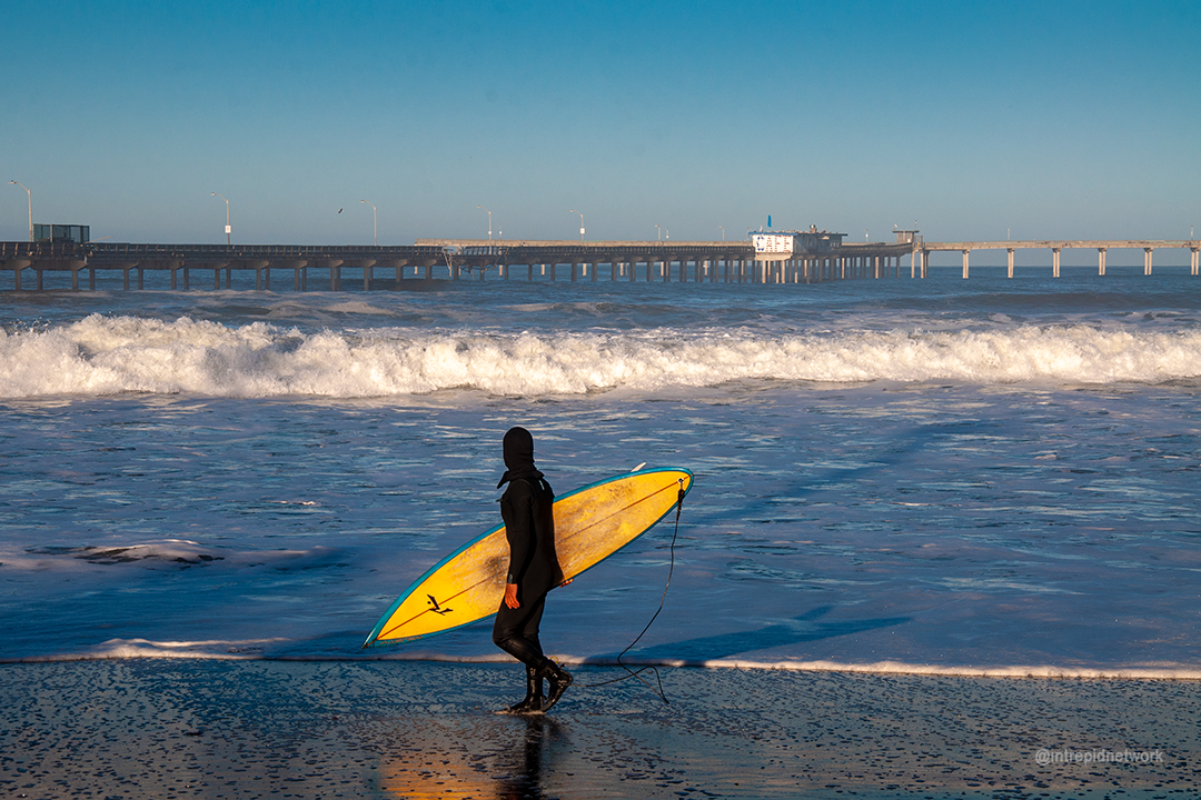 Surfer looking at OB Pier